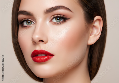 Beautiful woman with elegant makeup and bold red lips