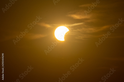 Bild auf Leinwand solar eclipse the moon obscures the sun sunset in the mountains