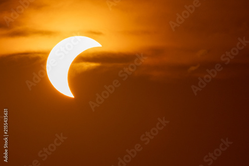 solar eclipse the moon obscures the sun sunset in the mountains