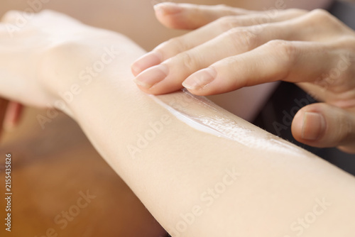 Applying Moisturizing Cream to Forearm