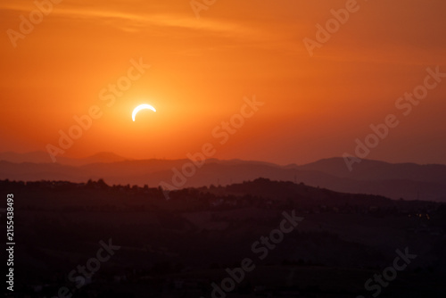 solar eclipse the moon obscures the sun sunset in the mountains