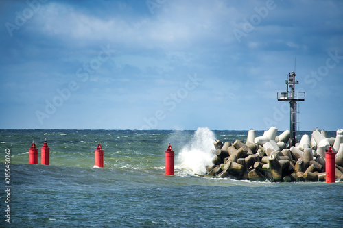 Konstfotografi Red Buoys and Breakwater With Waves Crashing Against Concrete Tetrapods and Navi