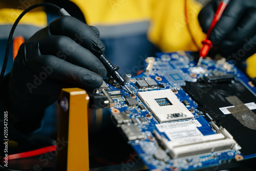 Electronics technician, electronic engineering electronic repair, electronics measuring and testing, repair and maintenance concepts.uses a voltage meter to check and upgrade in shop