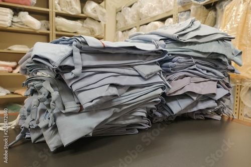 stack of neatly folded hospital linen prepared for use in a healthcare facility
