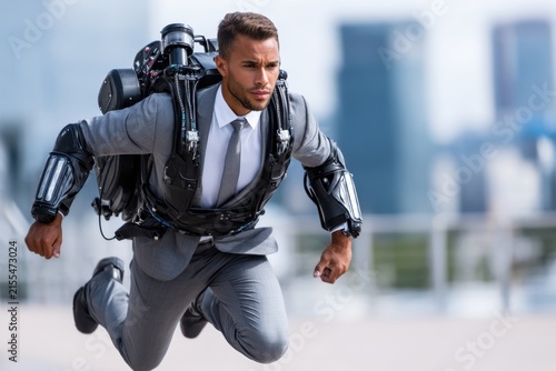 Jetpack suit wearer running on a city rooftop with skyscrapers in the background