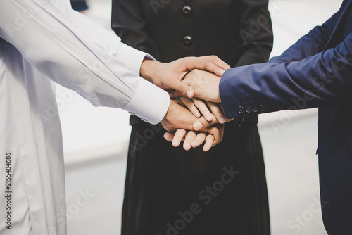 Business Team Joining Hands Together to Show Teamwork and Collaboration