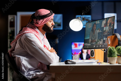 Middle Eastern Businessman Working Remotely in Online Video Conference at Modern Office