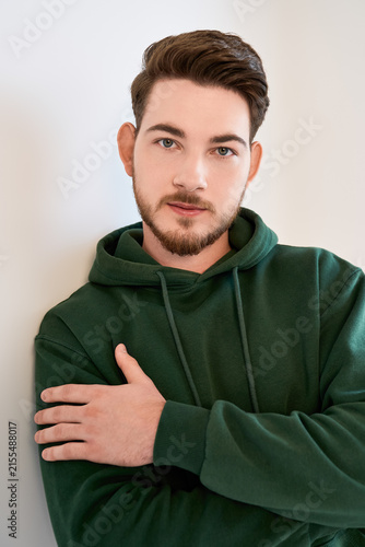 Konstfotografi Confident young man poses stylishly in a casual studio portrait