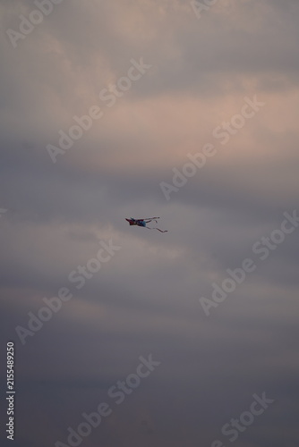 Photography Colorful kite flying in dramatic cloudy sky