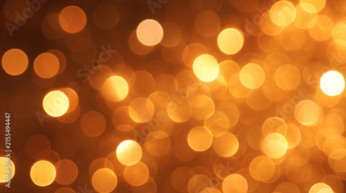 Golden Bokeh Background: A shimmering abstract background composed of out-of-focus golden circles, creating a warm and festive atmosphere. Perfect for celebrations and adding a touch of magic.