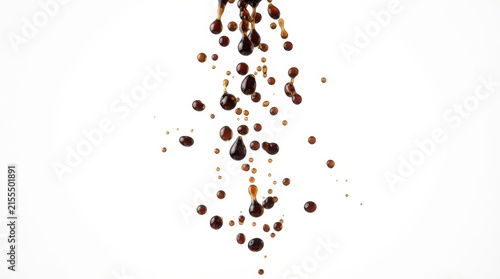 Close-up of dark sauce droplets on a light surface