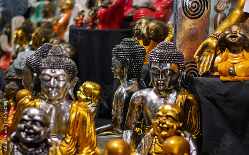 A fascinating collection of gold and silver Buddha statues carefully displayed in a market