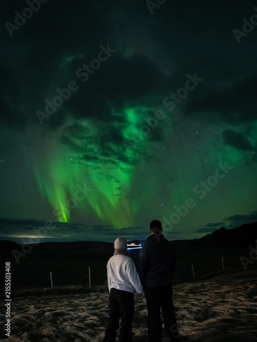 Majestic Tall Vertical View of Couple and Grand Swirling Aurora