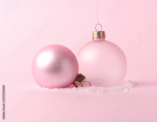 Pink Christmas Baubles Resting in Soft White Snow