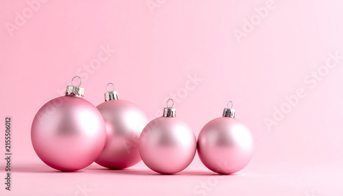 Row of Pink Christmas Baubles on Soft Pink Background