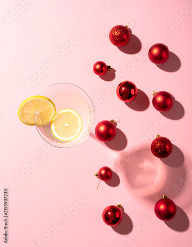 Lemon Slices and Red Baubles Scattered on Pink Background