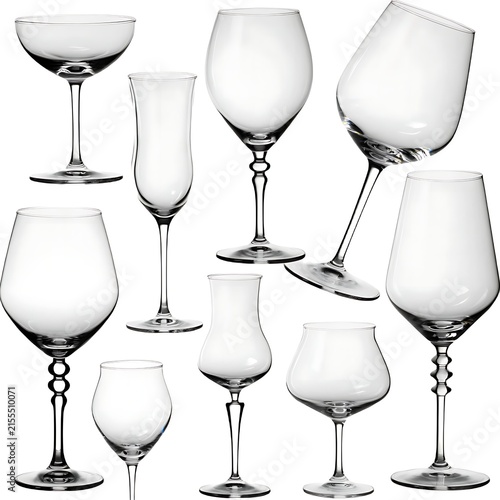 Various crystal stemware including flutes, coupes, and wine glasses arranged against a warm bokeh background lighting.