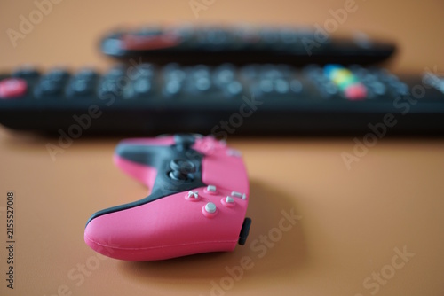 A toy game joystick on a brown background.