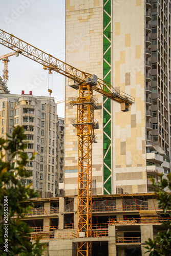 Bild auf Leinwand Tower crane at a construction site in urban areas