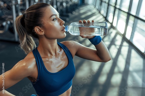 Female Model Taking Rest and Hydrating After Workout Training