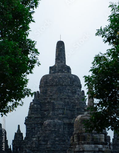 Foto Candi Sewu Main Stupa Framed by Green Trees in Prambanan Temple Complex, Central