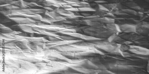 Fotografía Abstract crumpled paper texture with dramatic chiaroscuro lighting creating deep
