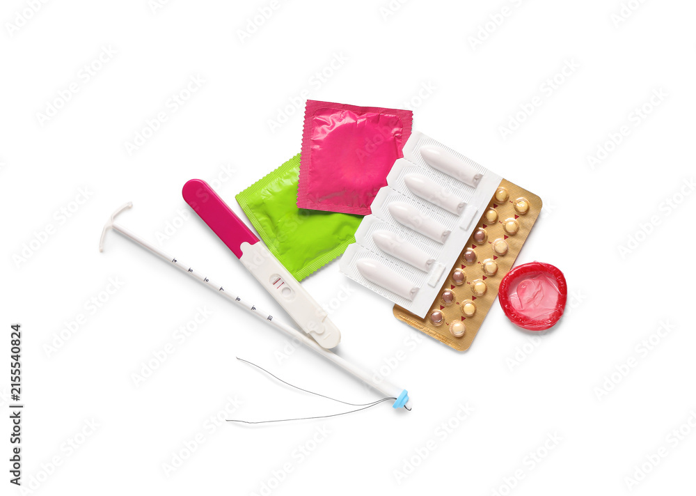 Fototapeta premium Various birth control methods and a positive pregnancy test on a white background, family planning and reproductive health