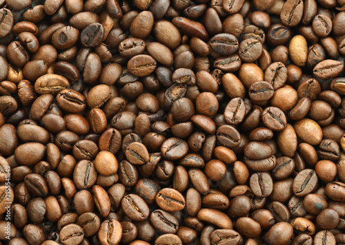 Photography Detailed view on brown roasted coffee beans in big pile on table close up