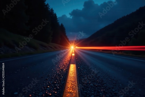 Streaks of headlight illumination on dark road, street, motion blur, dark
