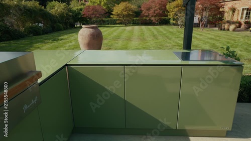 Modern green outdoor kitchen setup in a lush London garden