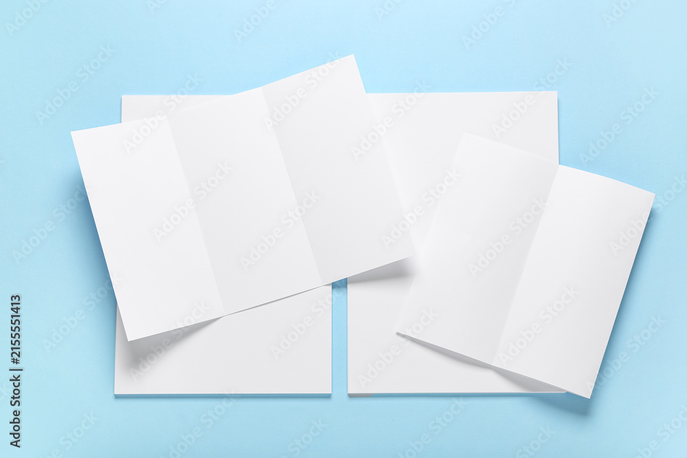 Fototapeta premium Different blank brochures on blue background
