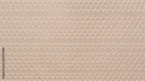Honeycomb mesh fabric texture provides a beige geometric background pattern.