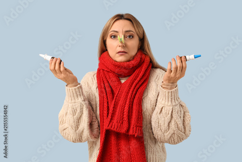 Konstfotografi Ill mature woman with clothespin and drops on light background
