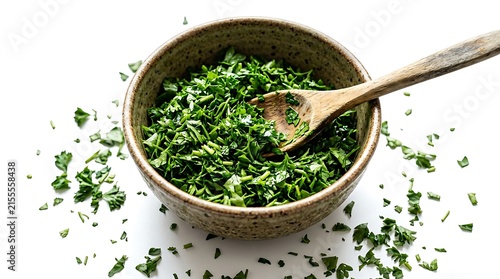 Fresh chopped parsley in a rustic bowl isolated on white background