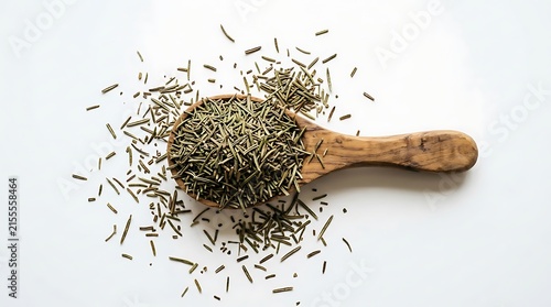 Dried rosemary leaves in a wooden spoon isolated on white background