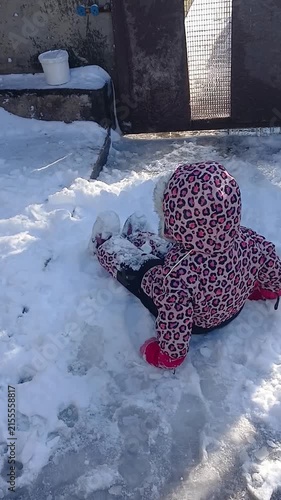 Child playing with snow in winter, part of a series