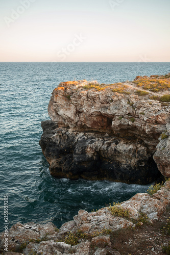 Beautiful seascape with rugged rocks, steep cliffs, and deep blue water