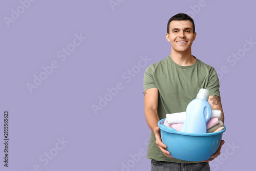 Young man with laundry bask...
