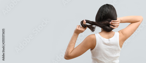 Принти на полотні Woman with dark hair styling a bun, hair care and beauty routine, healthy hair c