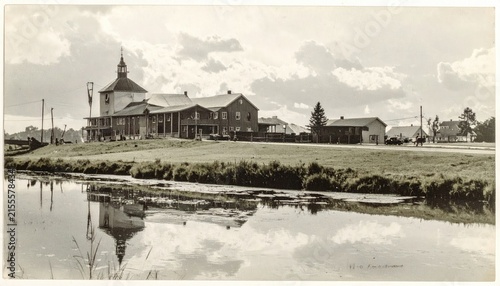 Historic Rural Church and Structures by Water Reflective Scene