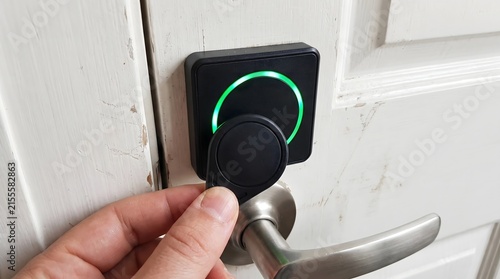 Naklejka Contactless rfid key fob unlocking smart door with green light indicator.