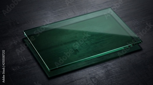 Rectangular green tinted glass pane resting on a dark textured wooden surface