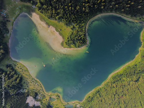 Stunning aerial drone view of the heart-shaped Trnovačko Lake. Trnovačko Lake nestled beneath Maglic, the highest peak in Bosnia and Herzegovina.