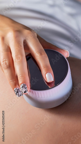 Obraz na płótnie Close up view of person hand holding round portable beauty device for skin treat