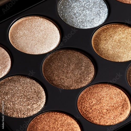 Close up of a sparkling eyeshadow palette with warm metallic tones