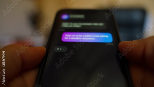 Hands holding smartphone asking AI assistant to write polite email about deadline extension