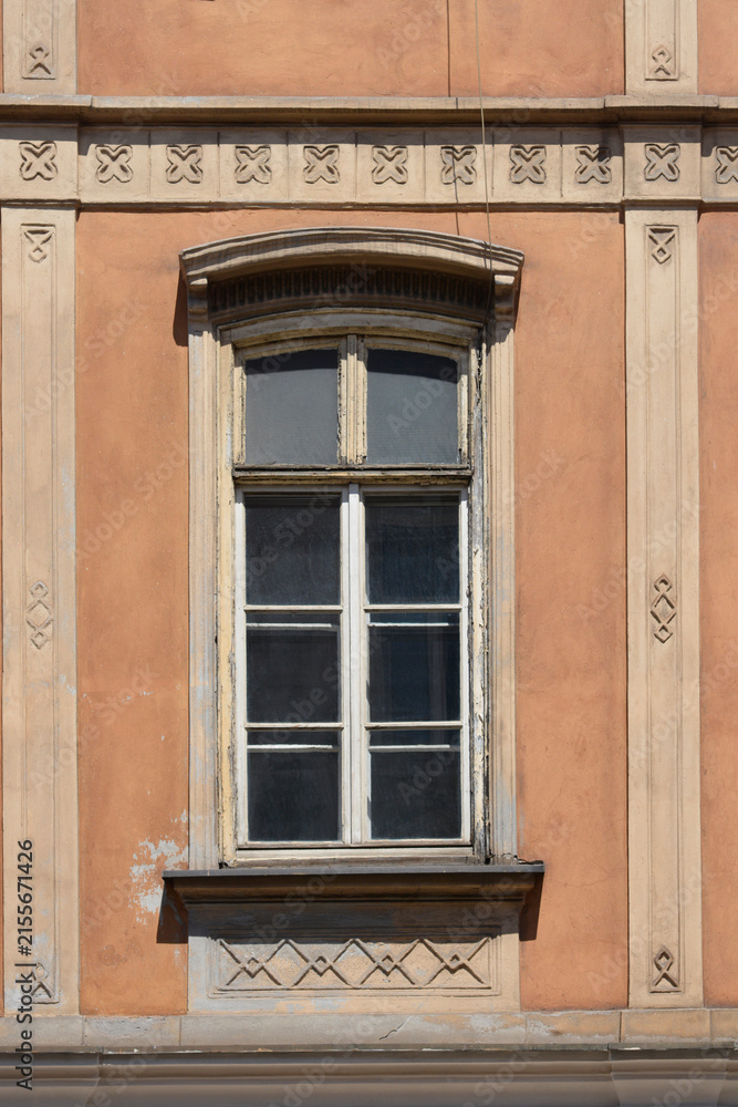 Fototapeta premium An elegant window on an old historicist building facade with vertical lines and stone geometric ornaments in Zagreb Croatia.