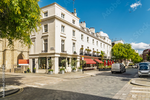 View of the elegant white stucco buildings and red awnings of a street in Belgravia, London, England, United Kingdom.