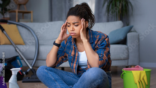 Quadro su tela Worried Black Female Feeling Overwhelmed As She Cleans Her Room At Home, Sitting