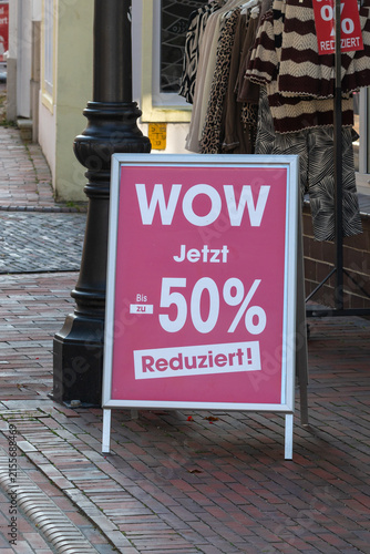 German sidewalk sign announcing 50 percent off sale